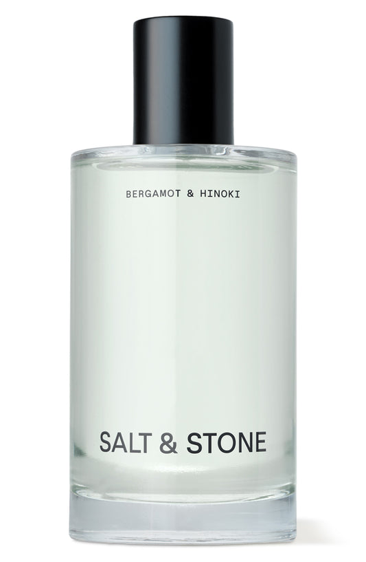 Clear bottle with black cap labeled 'Salt & Stone' on a white background